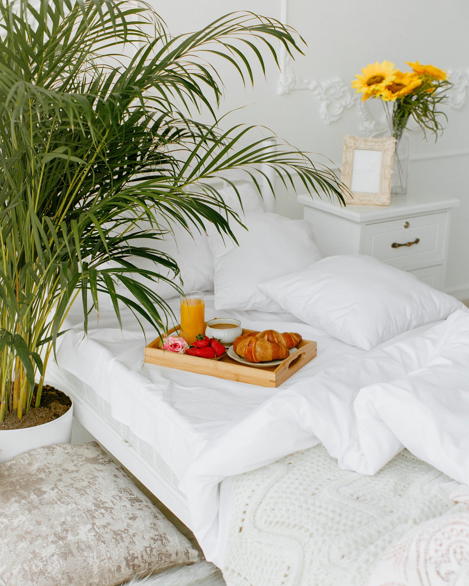 breakfast tray put on the single bed with white bedding